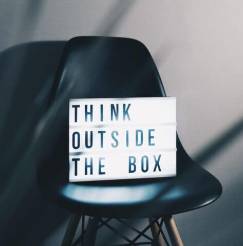 a lit sign sitting on a chair